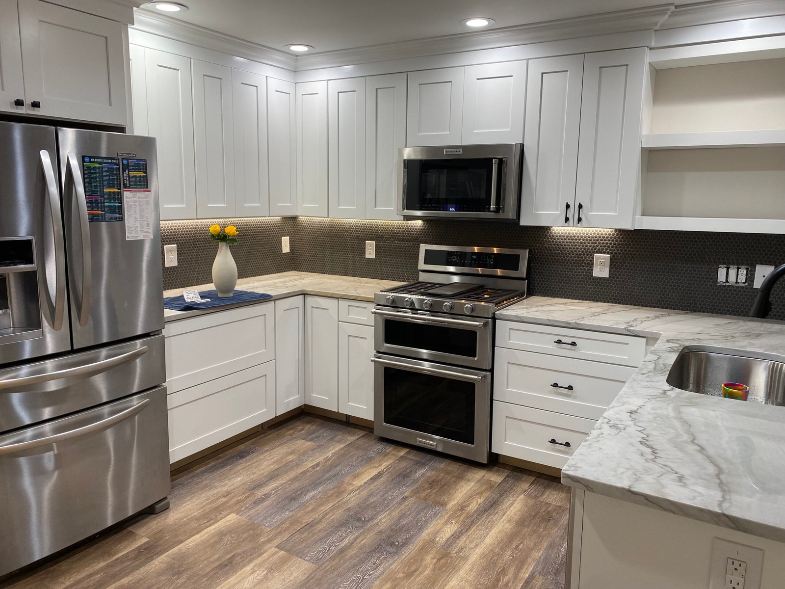 Kitchen remodel with white cabinetry and tile backsplash in Benton Harbor, MI